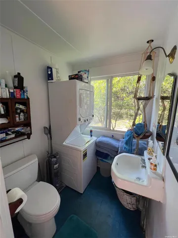 a bathroom with a toilet sink and mirror