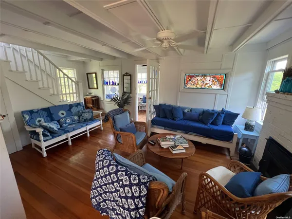 a living room with furniture a rug and a chandelier