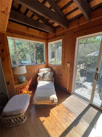 a bedroom with furniture and a large window