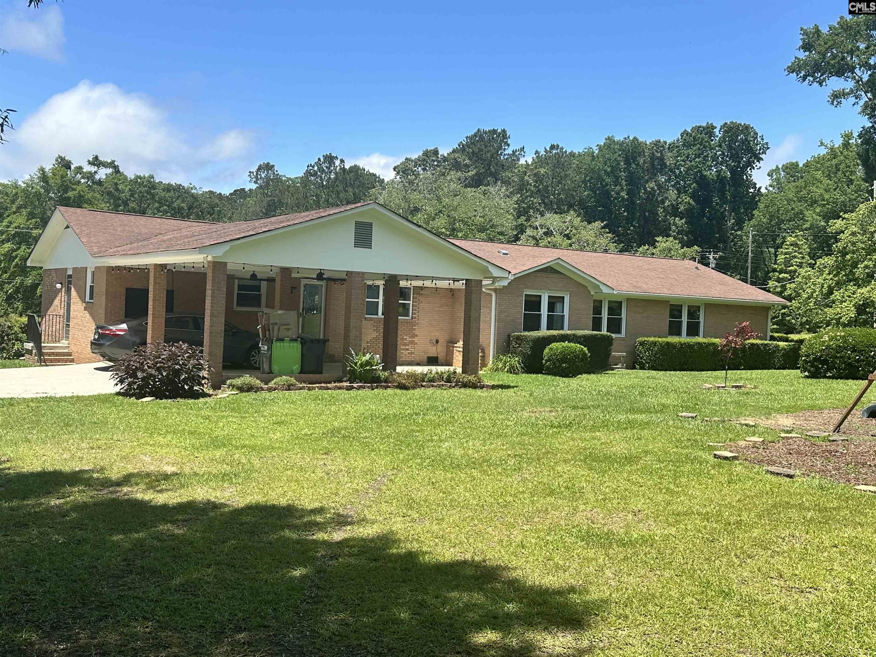 535 Sandbar Road Chapin, SC 29036 - Photo 8 of 23 a front view of a house with a garden