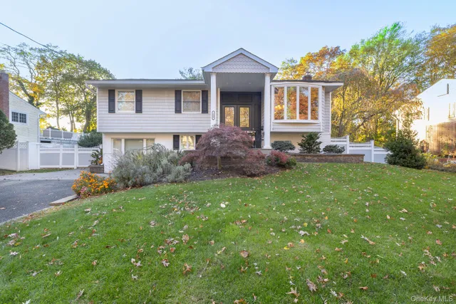 a front view of a house with a yard and a garage