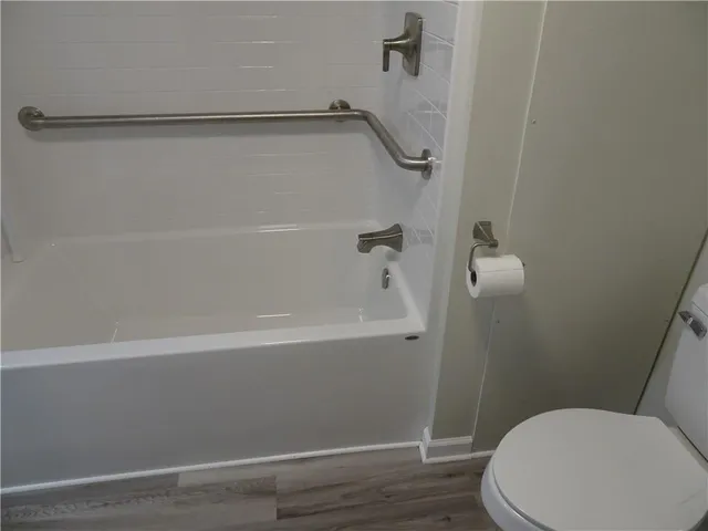 a bathroom with a bathtub and toilet