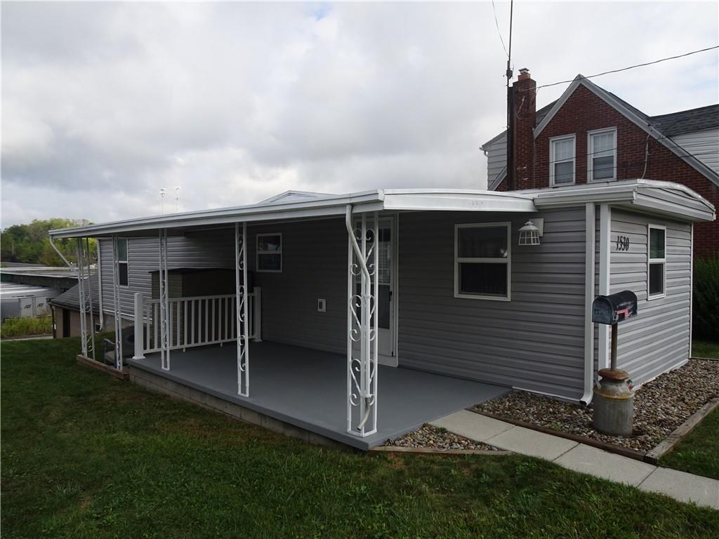 1530 Parr Street Greensburg, PA 15601 - Photo 3 of 16 a view of backyard with barbeque grill and wooden fence