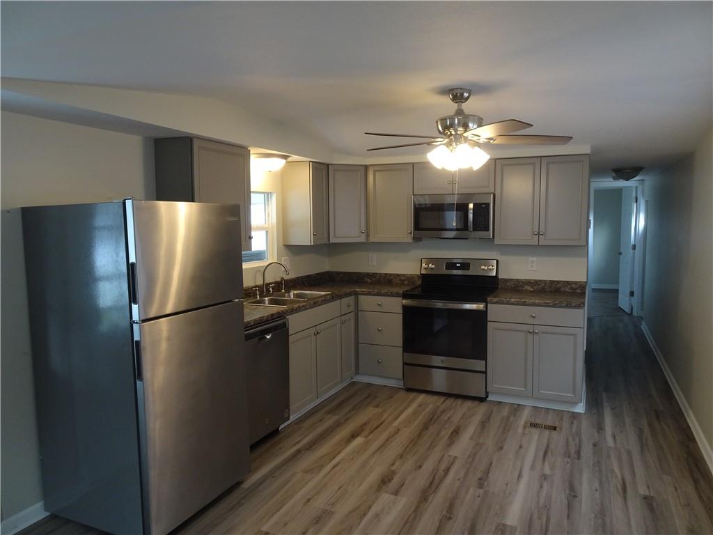 1530 Parr Street Greensburg, PA 15601 - Photo 4 of 16 a kitchen with a refrigerator and a stove top oven