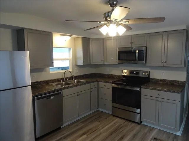 a kitchen with a sink stove and microwave