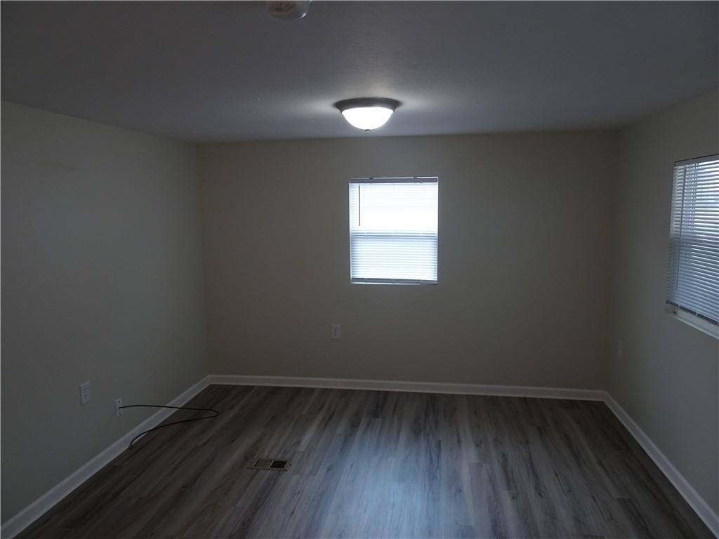 1530 Parr Street Greensburg, PA 15601 - Photo 8 of 16 an empty room with wooden floor and windows