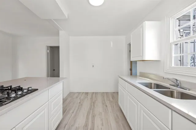 a kitchen with a sink stove and cabinets