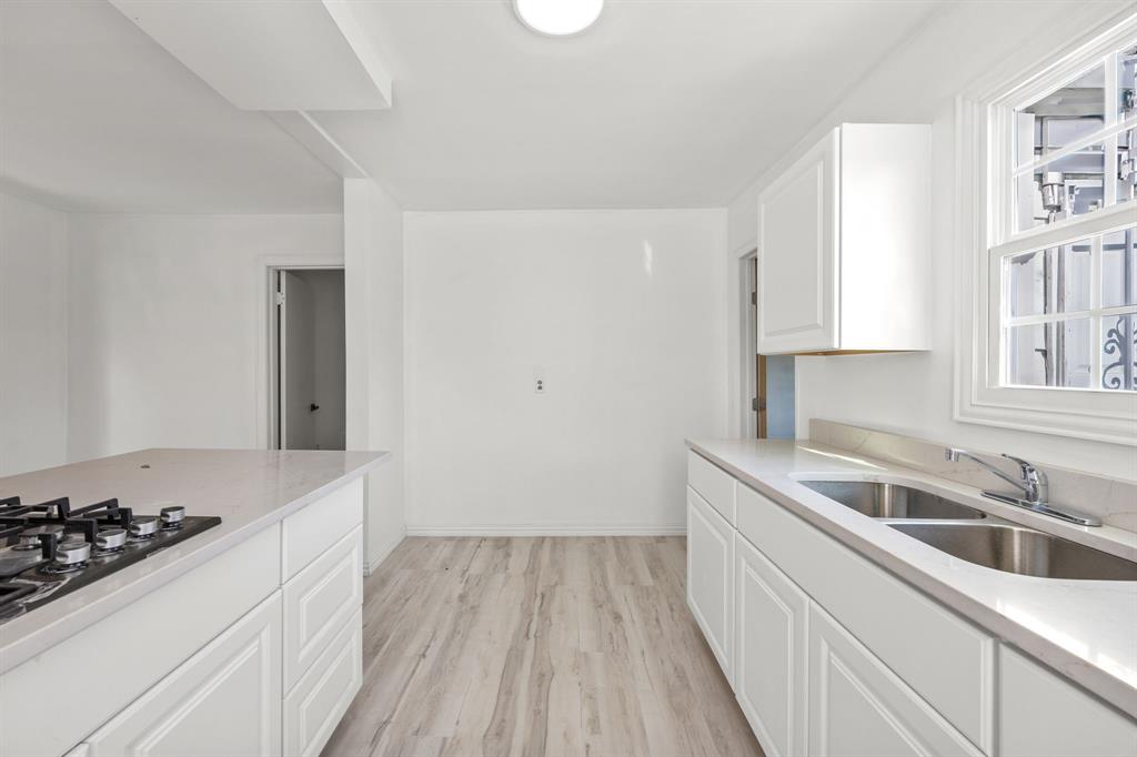 1802 Fordham Road Dallas, TX 75216 - Photo 13 of 25 a kitchen with a sink stove and cabinets