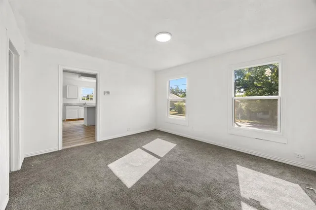 an empty room with windows and entrance