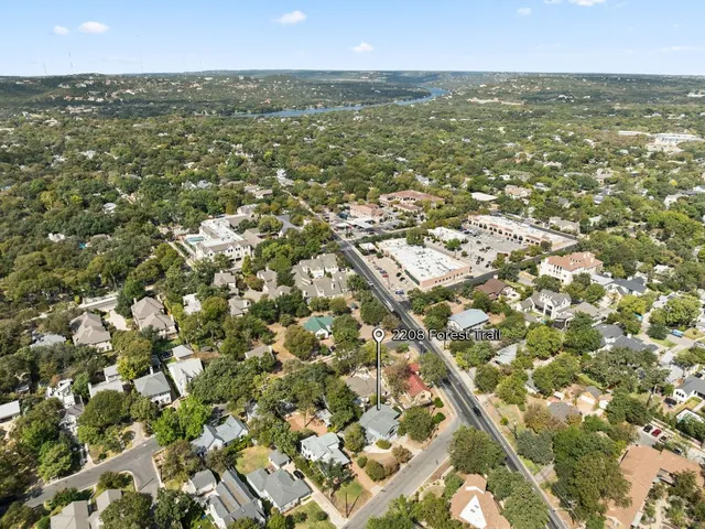 an aerial view of residential houses with city view