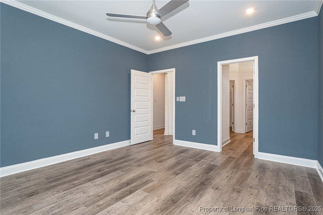 3211 Nottinghill Road Fayetteville, NC 28311 - Photo 12 of 39 an empty room with wooden floor and ceiling fan