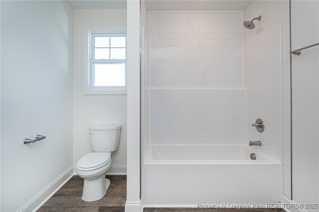 3211 Nottinghill Road Fayetteville, NC 28311 - Photo 31 of 39 a white toilet sitting next to a bath tub
