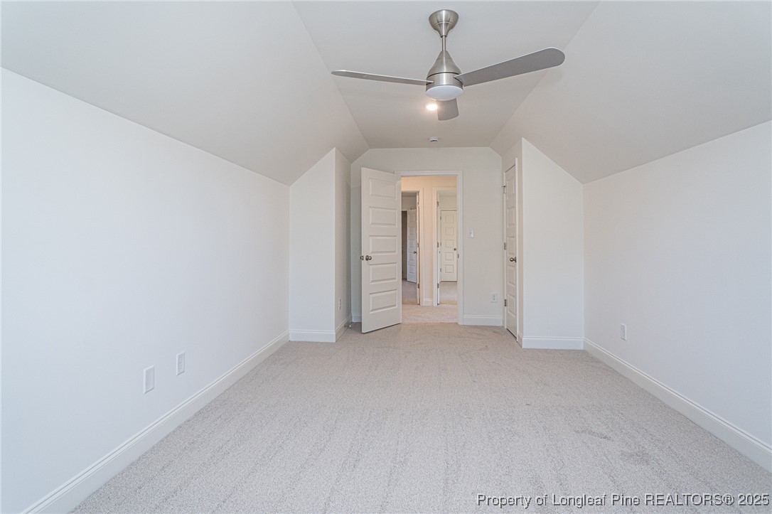 3211 Nottinghill Road Fayetteville, NC 28311 - Photo 35 of 39 an empty room with a chandelier fan and closet area