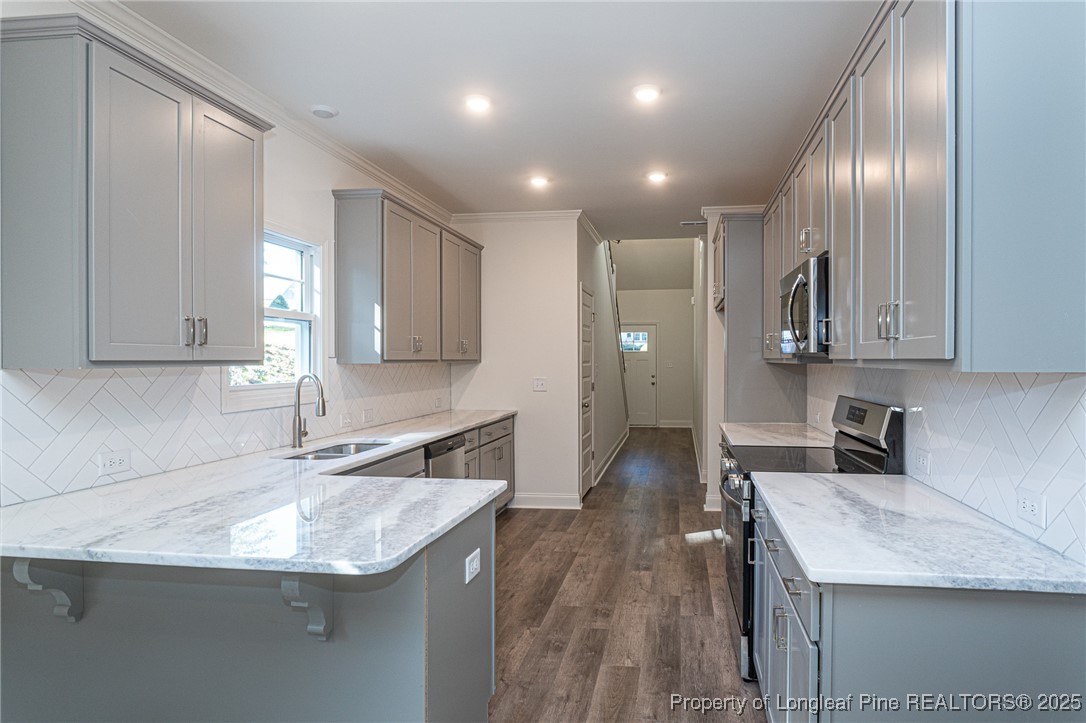 3211 Nottinghill Road Fayetteville, NC 28311 - Photo 7 of 39 a kitchen with stainless steel appliances granite countertop a sink stove and refrigerator