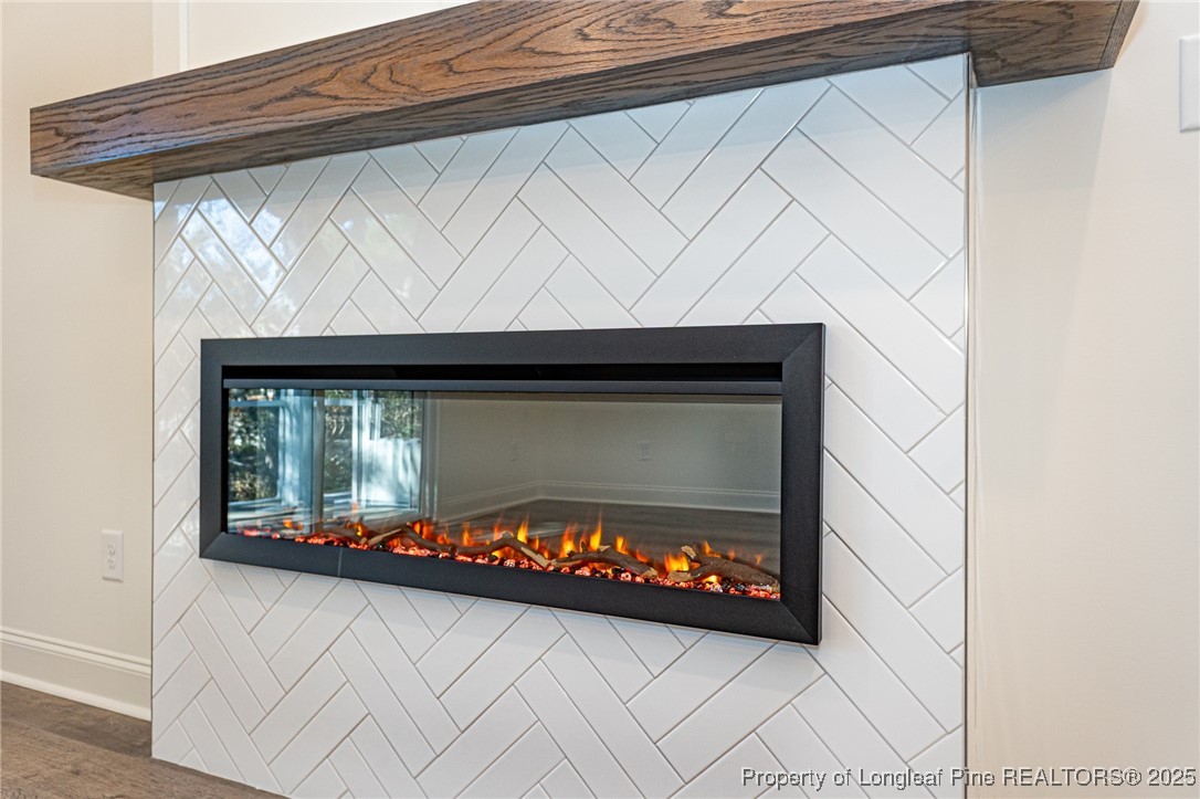 3211 Nottinghill Road Fayetteville, NC 28311 - Photo 9 of 39 a living room with a fireplace and a wooden floor