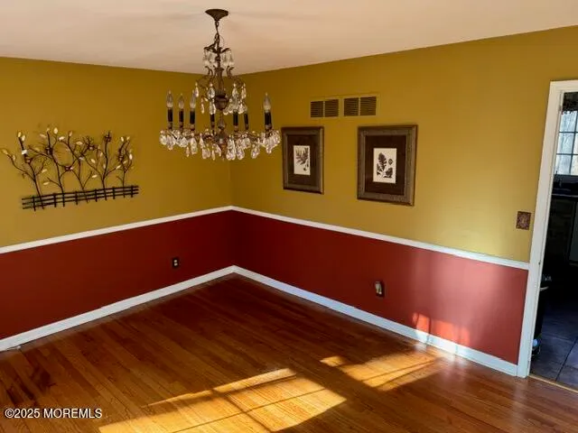 a view of room with window and wooden floor