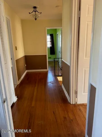 a view of a hallway view with wooden floor and staircase