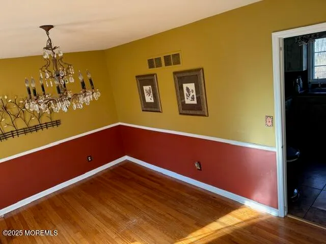 a view of a room with wooden floor and small space