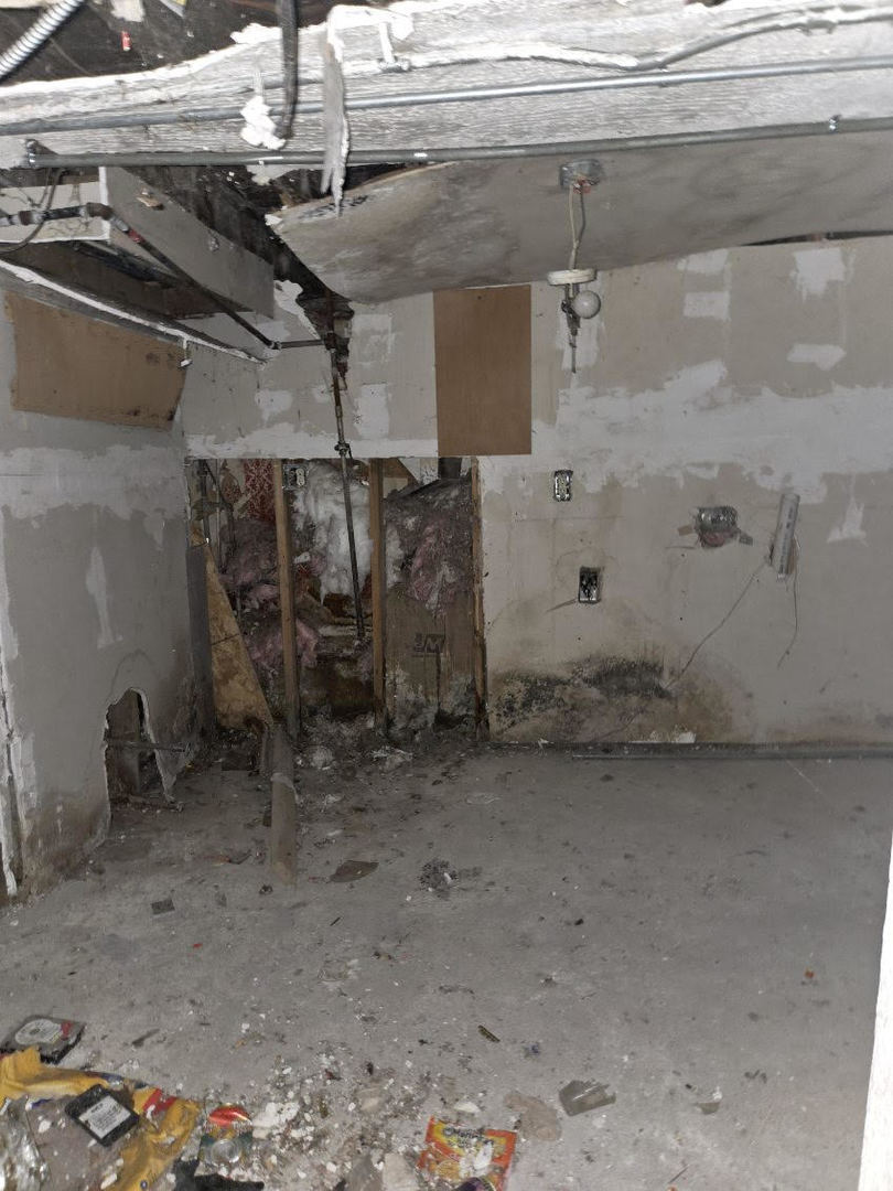 6619 South Aberdeen Street Chicago, IL 60621 - Photo 12 of 17 a room with water heater and a wooden cabinets