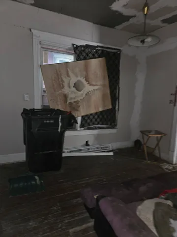 a living room with a wooden floor and a rug