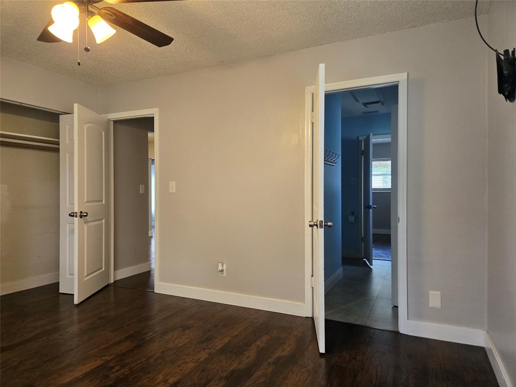 3559 Almar Road Palm Springs, FL 33461 - Photo 12 of 16 an empty room with wooden floor fan and windows