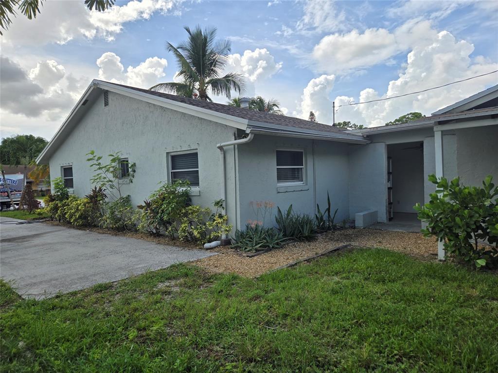 3559 Almar Road Palm Springs, FL 33461 - Photo 15 of 16 a house view with a garden space