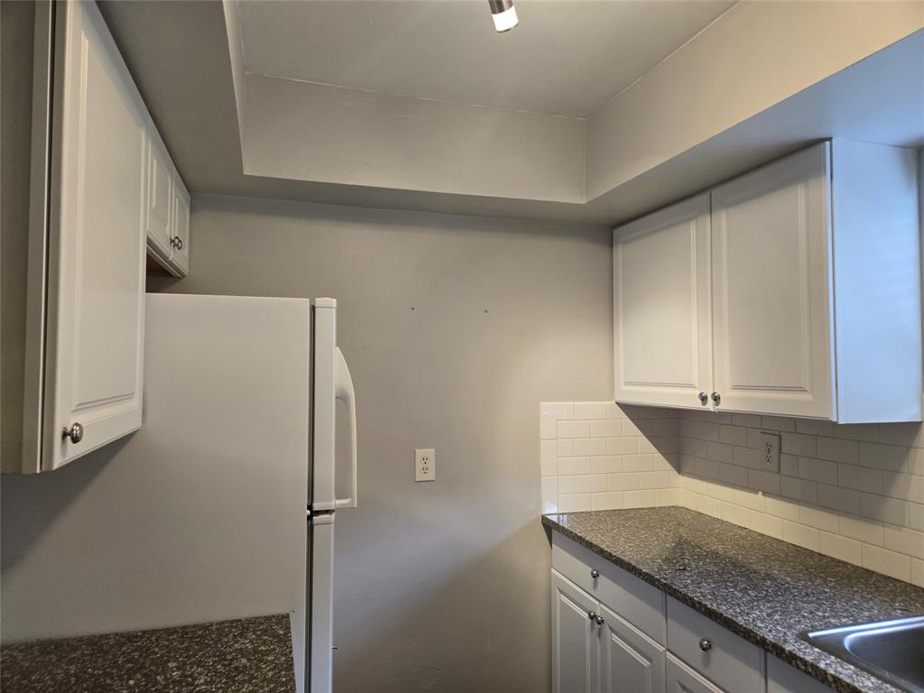 3559 Almar Road Palm Springs, FL 33461 - Photo 6 of 16 a kitchen with a refrigerator and a sink