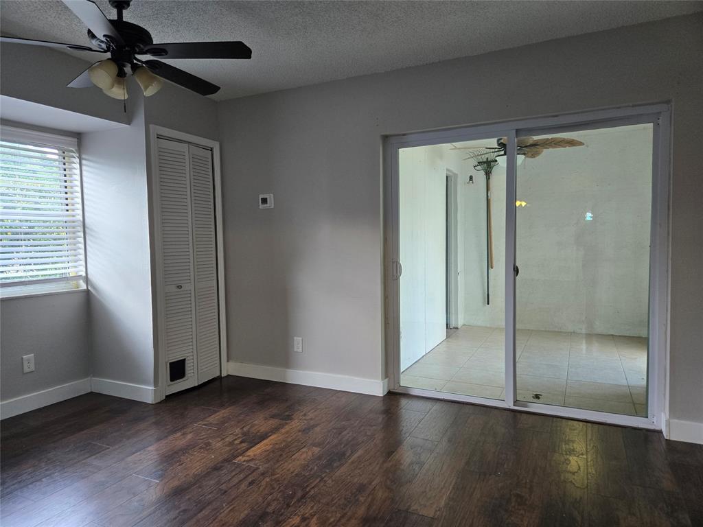 3559 Almar Road Palm Springs, FL 33461 - Photo 8 of 16 an empty room with wooden floor closet and windows