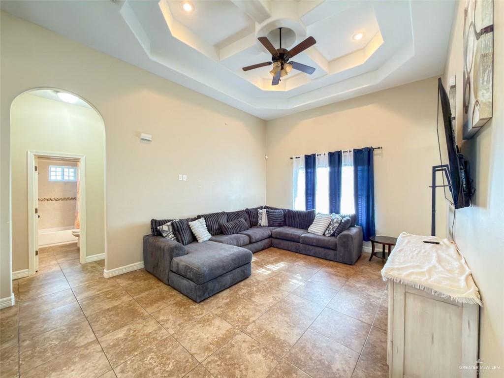 208 North 15th Street Hidalgo, TX 78557 - Photo 12 of 26 a living room with furniture and a chandelier