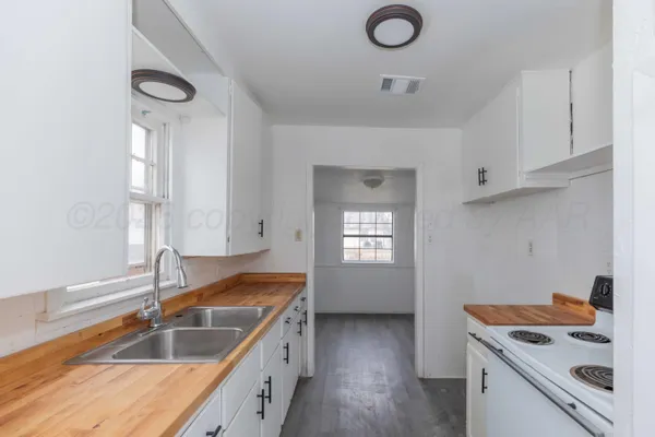 a kitchen with a sink and cabinets