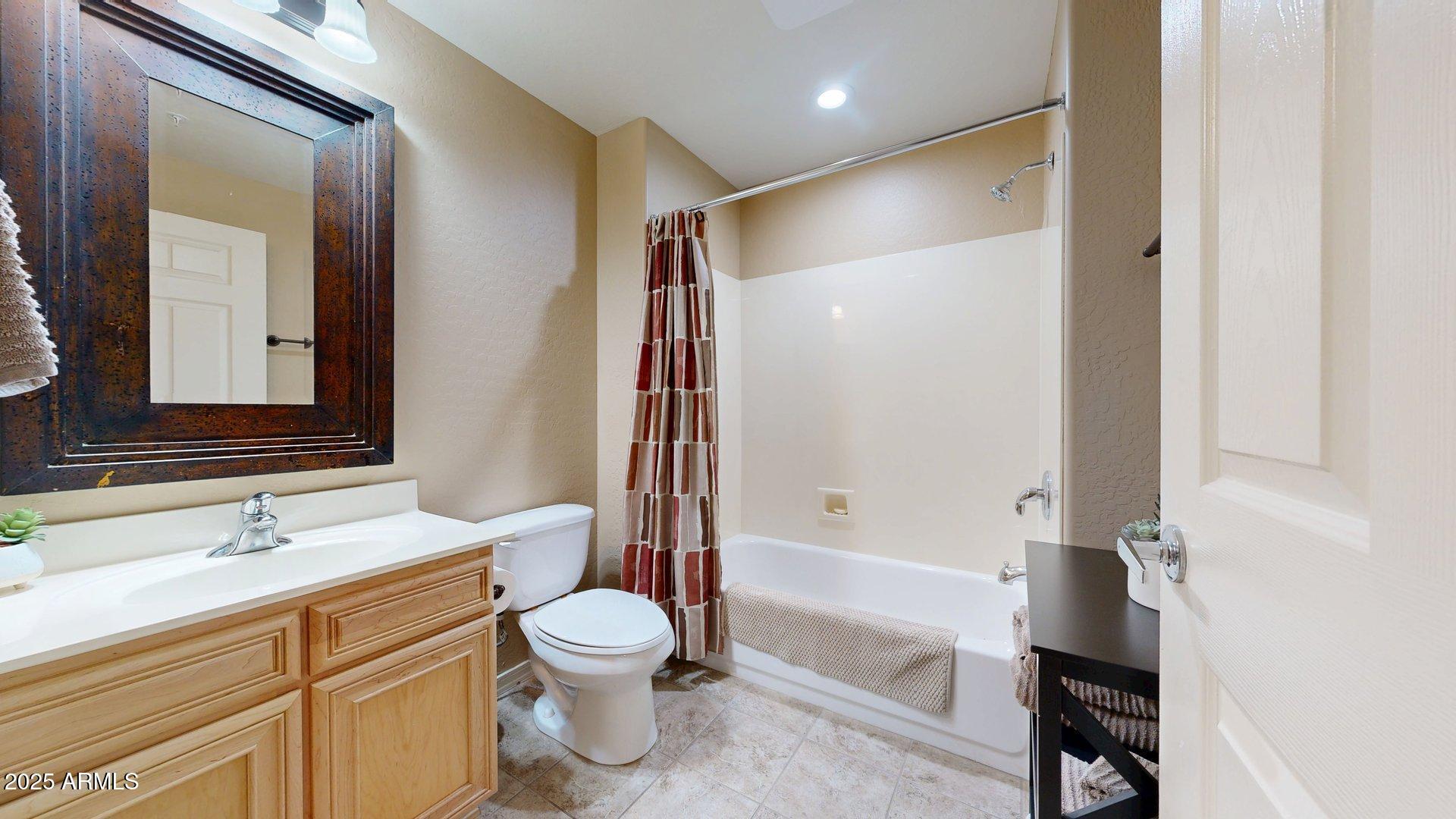 20121 North 76th Street, Unit 1047 Scottsdale, AZ 85255 - Photo 13 of 22 a bathroom with a sink toilet and shower