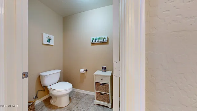 a white toilet sitting next to a bathroom sink