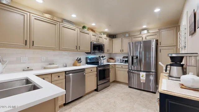 a kitchen with a sink stainless steel appliances and cabinets