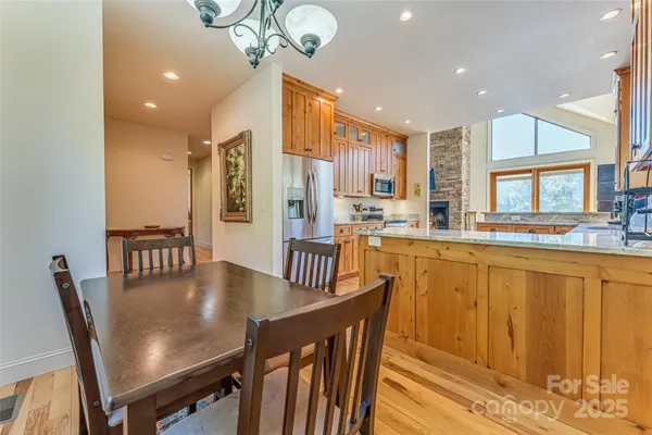 a view of a dining room with furniture a chandelier and wooden floor