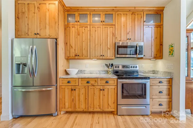 a kitchen with granite countertop a refrigerator and a stove