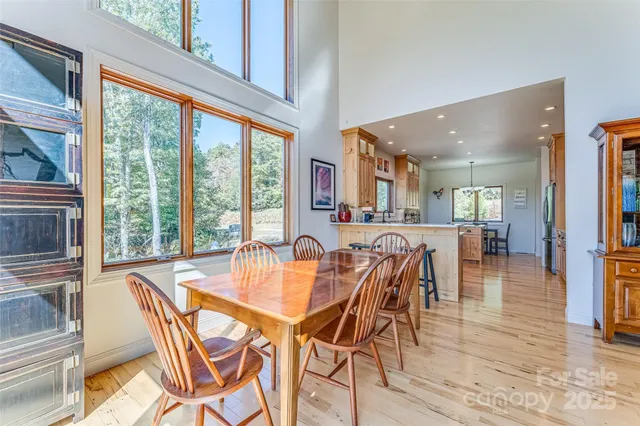 a dining room with furniture and large windows