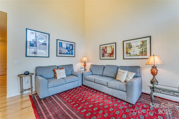 a living room with furniture a rug and a table