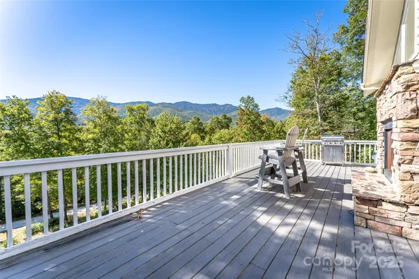 a view of a chairs and table on the wooden deck