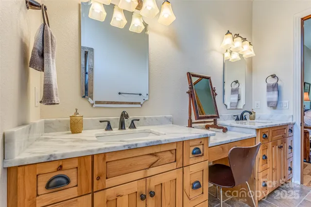 a bathroom with a sink double vanity granite and a mirror