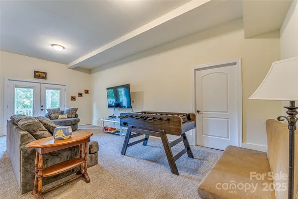 a living room with furniture a rug and a table