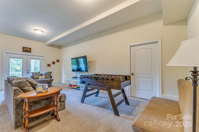 a living room with furniture a rug and a table