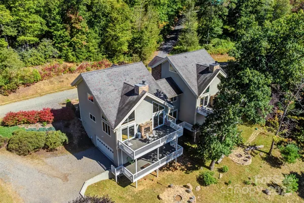 an aerial view of a house with a yard basket ball court and outdoor seating