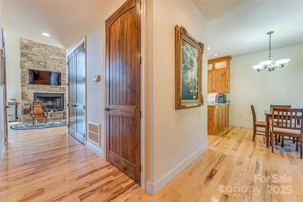 a view of a livingroom kitchen and dinning room with wooden floor