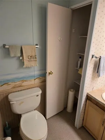 a white toilet sitting next to a bathroom sink