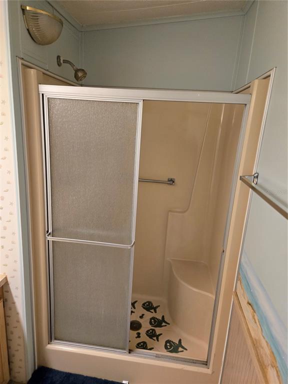 6162 Redwing Avenue Englewood, FL 34224 - Photo 16 of 23 a bathroom with a bathtub and a shower