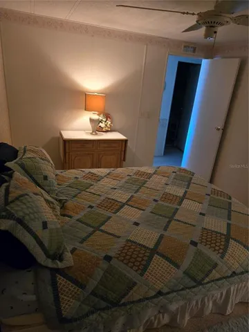 a bedroom with a bed and a night stand