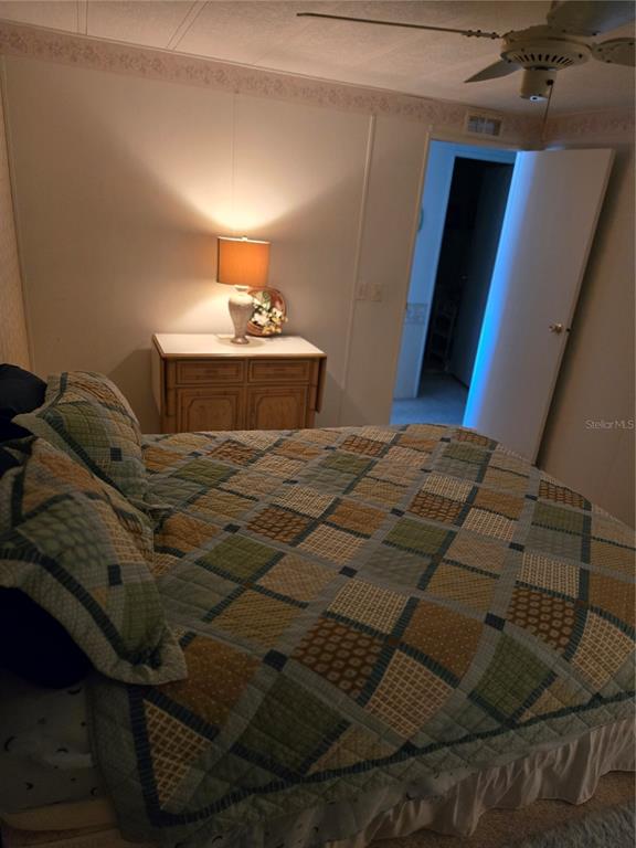 6162 Redwing Avenue Englewood, FL 34224 - Photo 17 of 23 a bedroom with a bed and a night stand