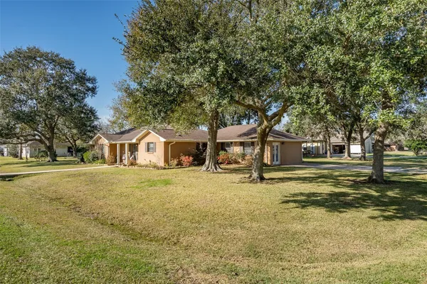 a big house with trees in front of it
