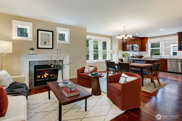 a living room with furniture a fireplace and wooden floor