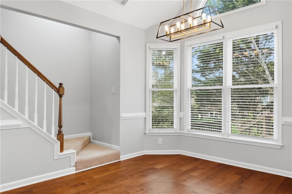 3875 Montvale Crossing Cumming, GA 30041 - Photo 20 of 53 a view of an empty room with wooden floor and a window